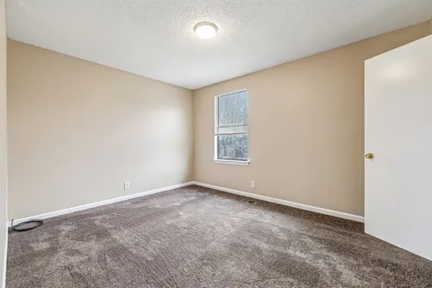 an empty room with a empty space and a window