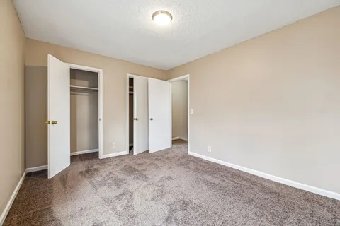 an empty room with closet area