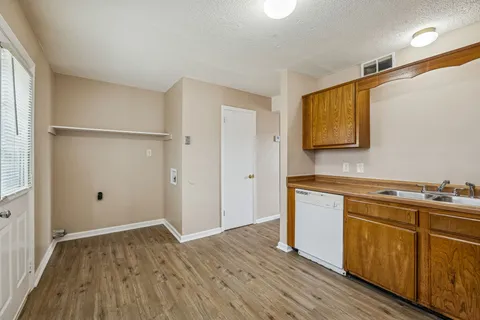 a view of a kitchen with wooden floor