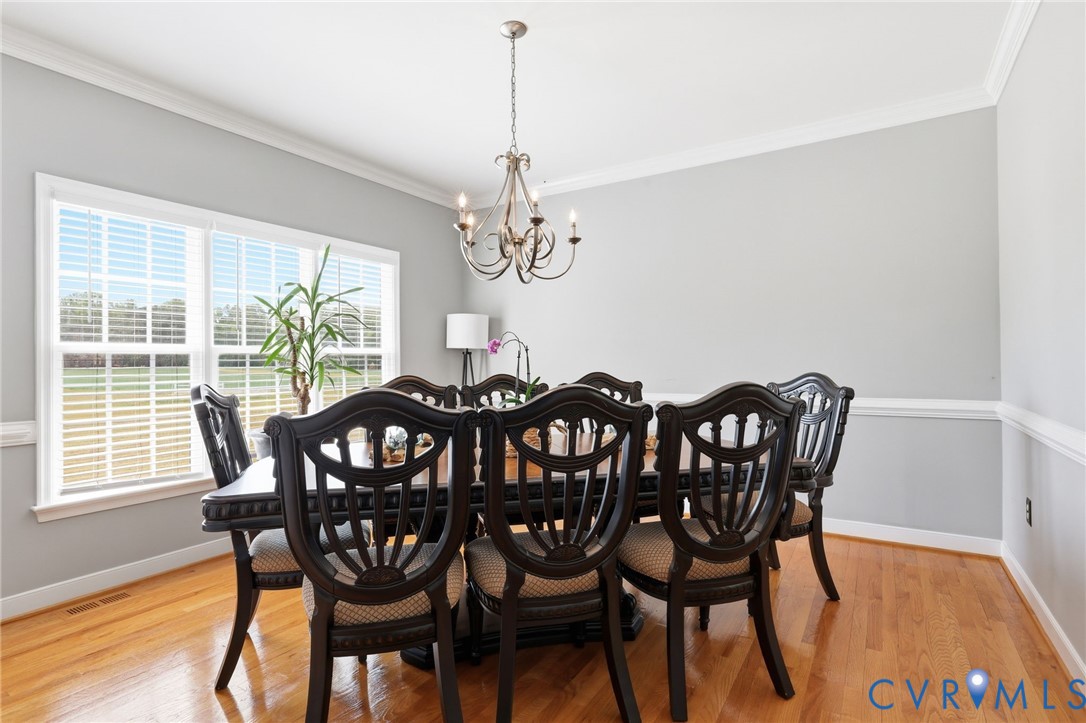 2018 Old Church Road Mechanicsville, VA 23111 - Photo 11 of 49 a view of a dining room with furniture a chandelier and wooden floor