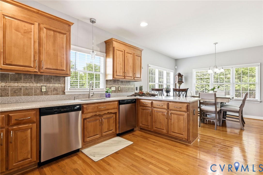 2018 Old Church Road Mechanicsville, VA 23111 - Photo 15 of 49 a kitchen with stainless steel appliances granite countertop a stove top oven a sink dishwasher and cabinets with wooden floor