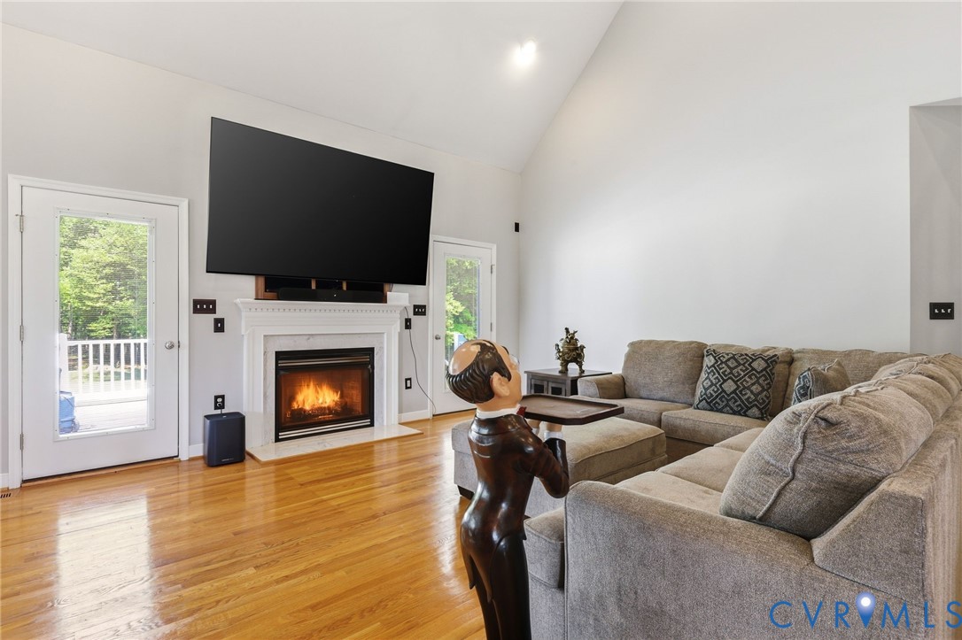 2018 Old Church Road Mechanicsville, VA 23111 - Photo 18 of 49 a living room with furniture a flat screen tv and a fireplace