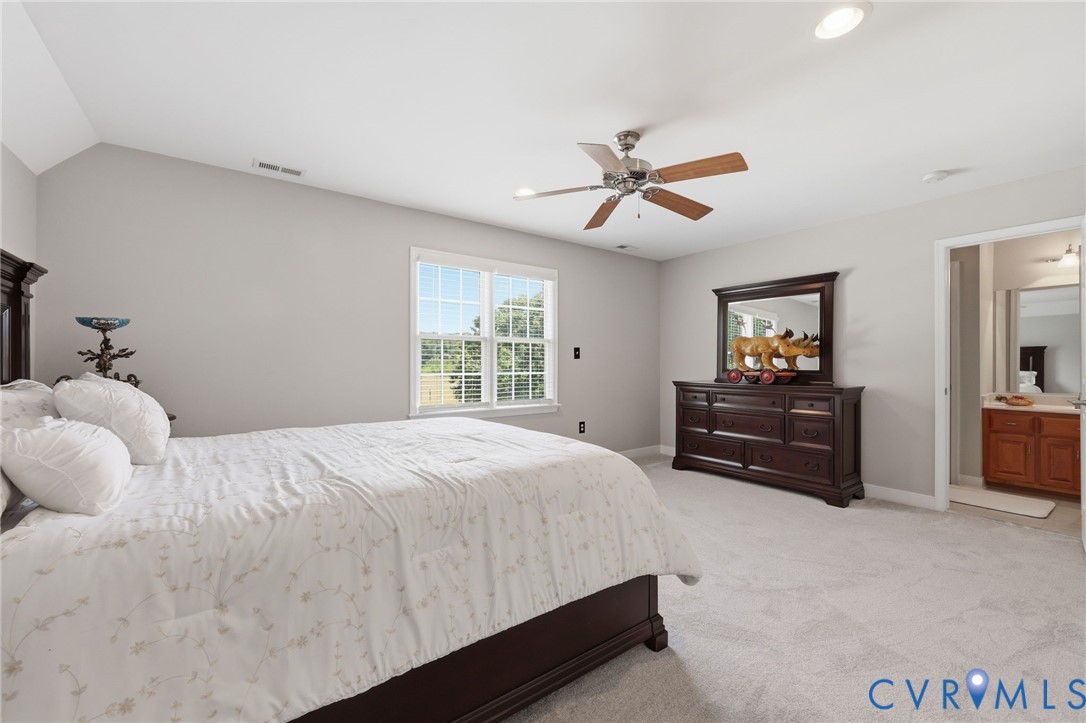 2018 Old Church Road Mechanicsville, VA 23111 - Photo 28 of 49 a bedroom with a bed and a chandelier