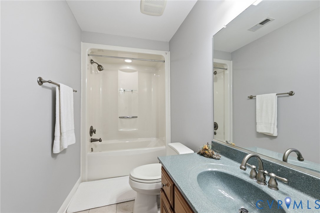 2018 Old Church Road Mechanicsville, VA 23111 - Photo 33 of 49 a bathroom with a granite countertop sink toilet a mirror and shower