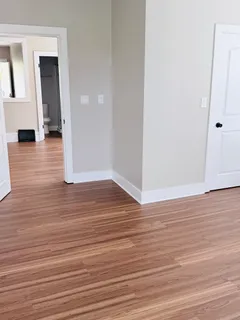a view of a room with wooden floor