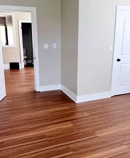 a view of a room with wooden floor