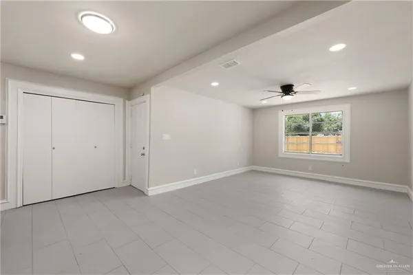 an empty room with windows and entrance