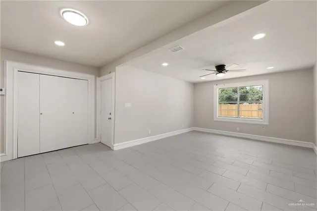 an empty room with windows and entrance