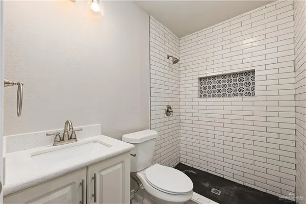 a bathroom with a toilet a sink and mirror
