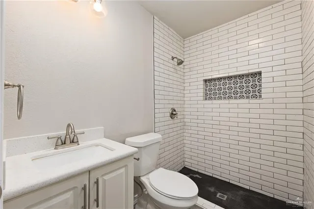 a bathroom with a toilet a sink and mirror