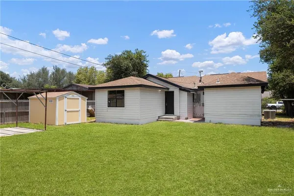 a front view of a house with yard and a garage