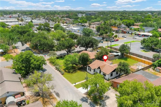 an aerial view of a house with a yard