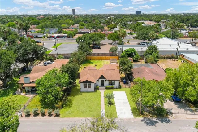 an aerial view of residential houses with outdoor space and swimming pool