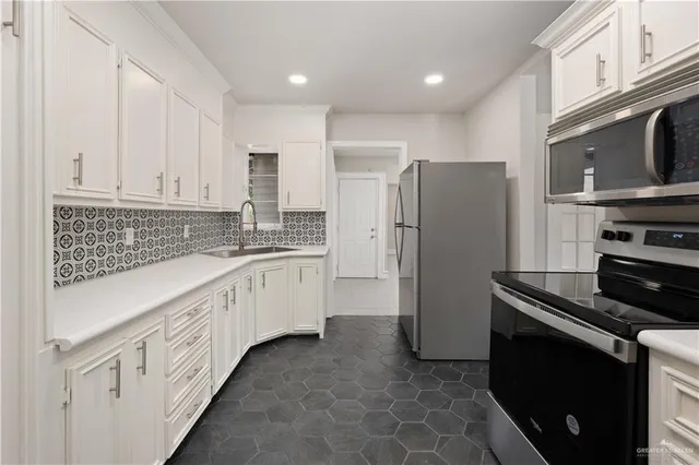 a kitchen with granite countertop cabinets and steel stainless steel appliances