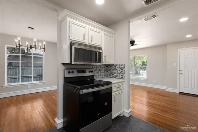 a kitchen with a stove and a microwave