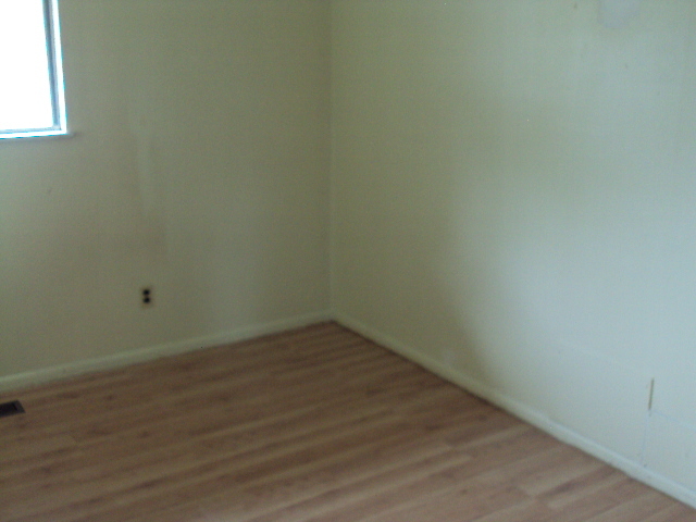 2901 Alton Drive Champaign, IL 61821 - Photo 13 of 19 a view of an empty room with wooden floor and a window