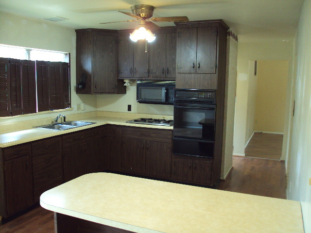 2901 Alton Drive Champaign, IL 61821 - Photo 2 of 19 a kitchen with a wooden floor and cabinets