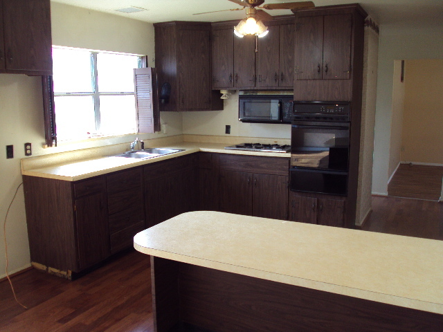 2901 Alton Drive Champaign, IL 61821 - Photo 3 of 19 a kitchen with stainless steel appliances a sink a stove a refrigerator cabinets and a dining table