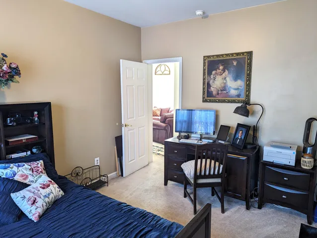 front view of house with a yard and potted plants