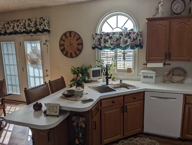 a living room with furniture a flat screen tv and a floor to ceiling window