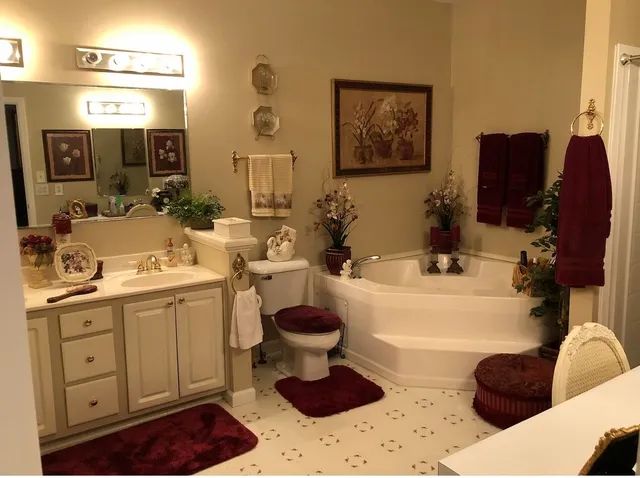 a bathroom with a sink a toilet and a mirror