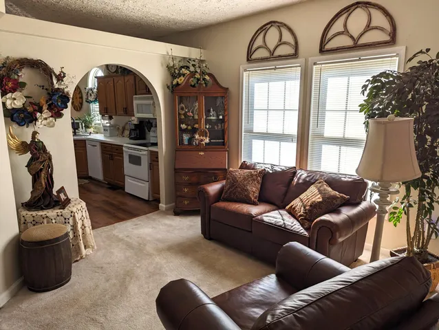 a view of a livingroom with furniture and bathroom