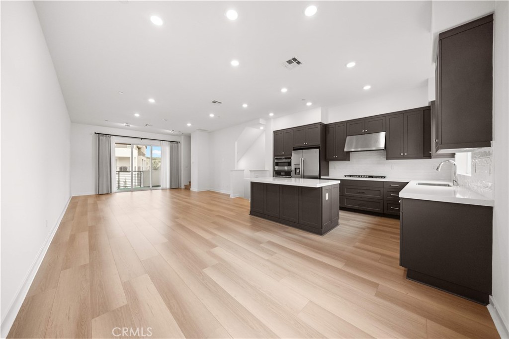 312 Tank Irvine, CA 92618 - Photo 16 of 68 a large kitchen with a large counter top a sink stainless steel appliances and cabinets