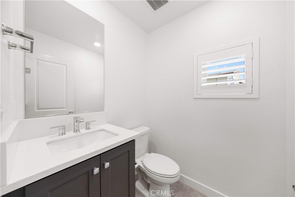 312 Tank Irvine, CA 92618 - Photo 27 of 68 a bathroom with a toilet a sink and mirror