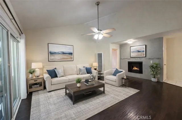 a living room with furniture a fireplace and a chandelier