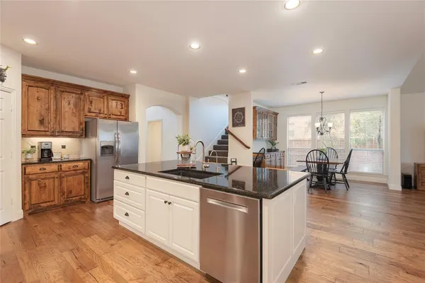 a kitchen with granite countertop cabinets a dining table and chairs