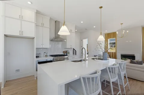 a bathroom with double vanity sinks a vanity a lamp and a mirror