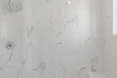 a view of an empty room with wooden floor and windows