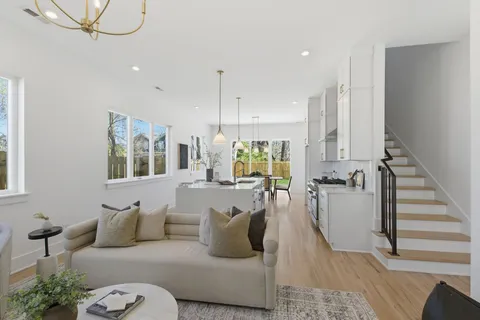 a large kitchen with kitchen island a large counter top space a sink stainless steel appliances and cabinets