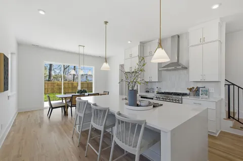 a view of a dining room with furniture wooden floor and a chandelier