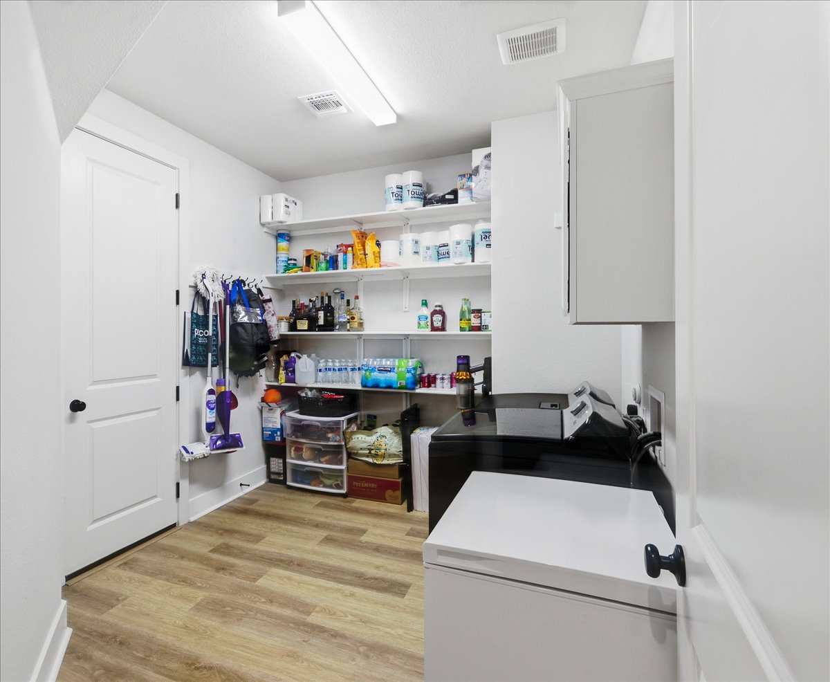 117 Peacevine Lane Georgetown, TX 78628 - Photo 25 of 31 Bonus Pantry space + Laundry Suite