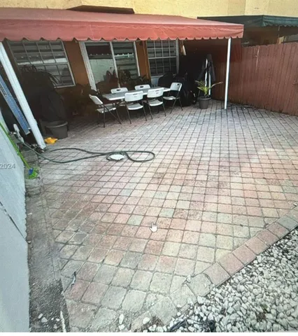 a view of a patio with wooden floor