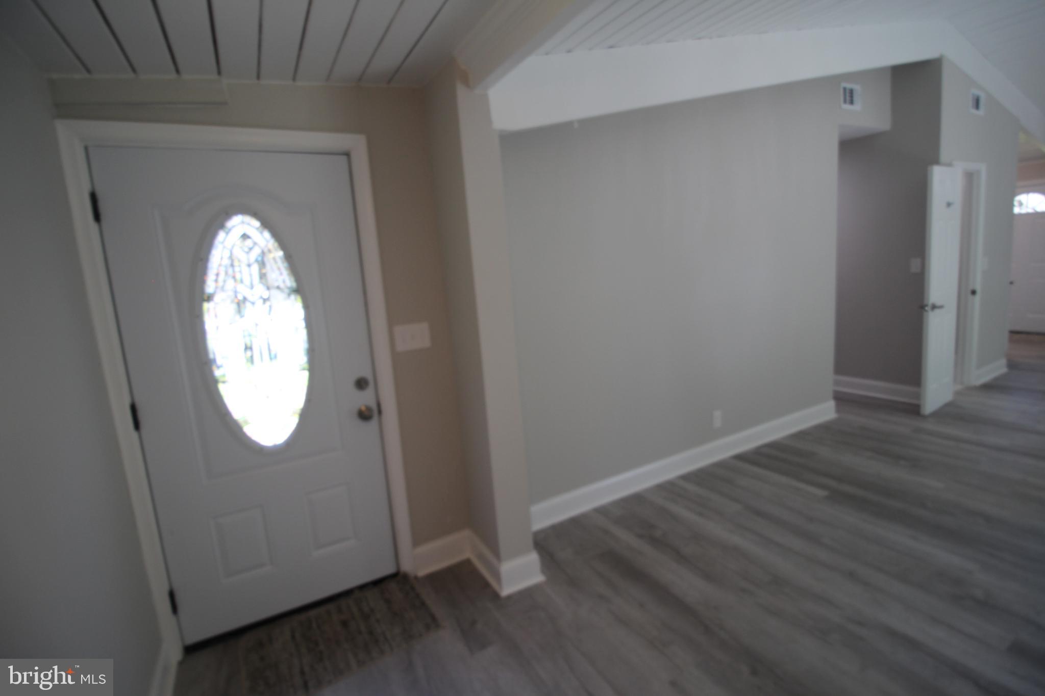 2704 Harris Avenue Silver Spring, MD 20902 - Photo 8 of 24 an empty room with wooden floor mirror and window