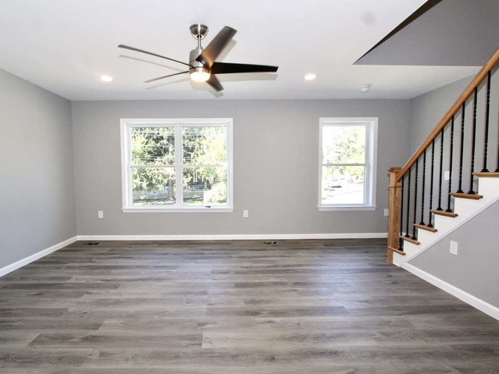 26 Apthorp Street Worcester, MA 01606 - Photo 2 of 13 a view of an empty room with wooden floor and a window