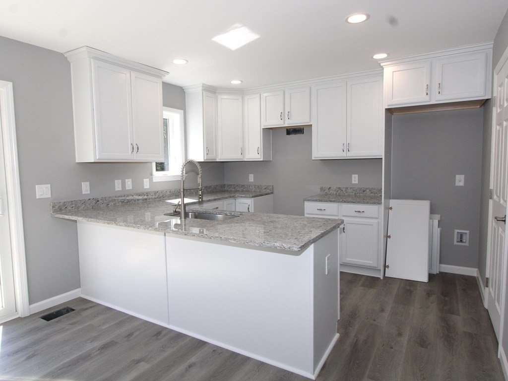 26 Apthorp Street Worcester, MA 01606 - Photo 3 of 13 a kitchen with granite countertop a sink stainless steel appliances and cabinets