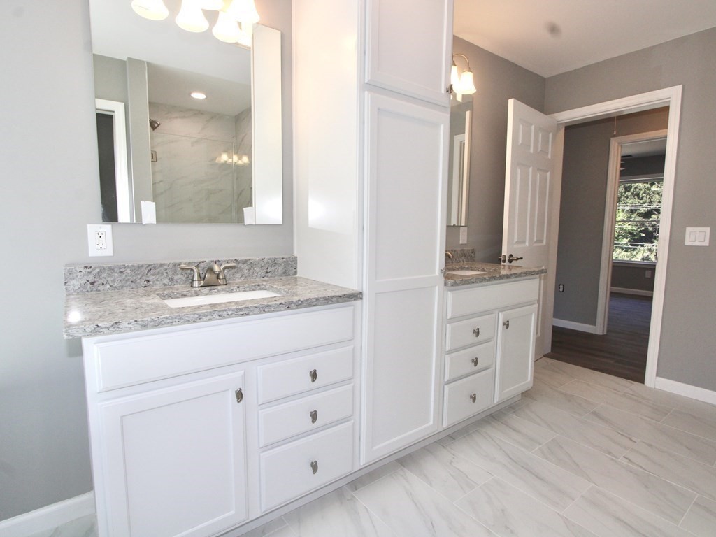 26 Apthorp Street Worcester, MA 01606 - Photo 4 of 13 a bathroom with a granite countertop sink mirror and double