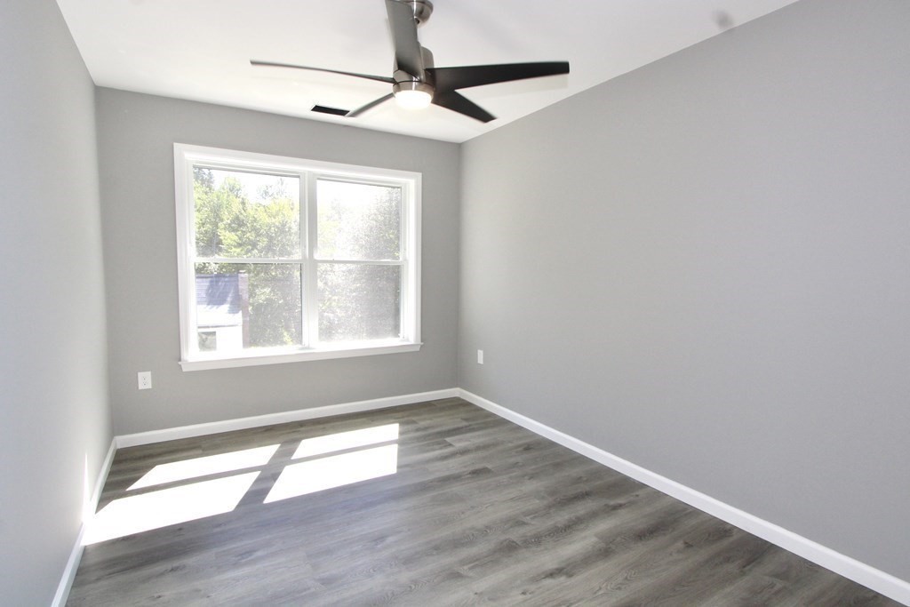 26 Apthorp Street Worcester, MA 01606 - Photo 9 of 13 a view of an empty room with wooden floor and a window