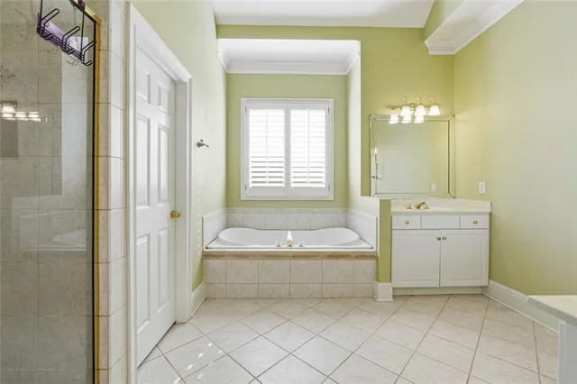a spacious bathroom with a tub sink and mirror