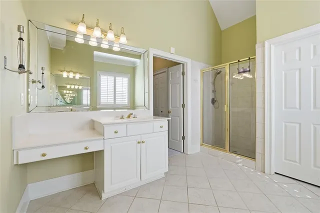 a bathroom with a double vanity sink mirror and a shower