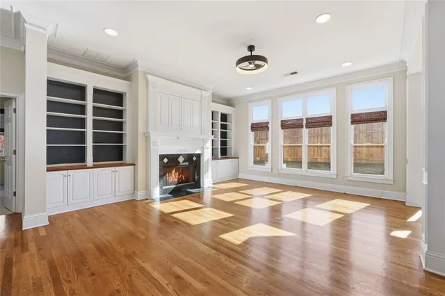 a view of a livingroom with a fireplace and windows
