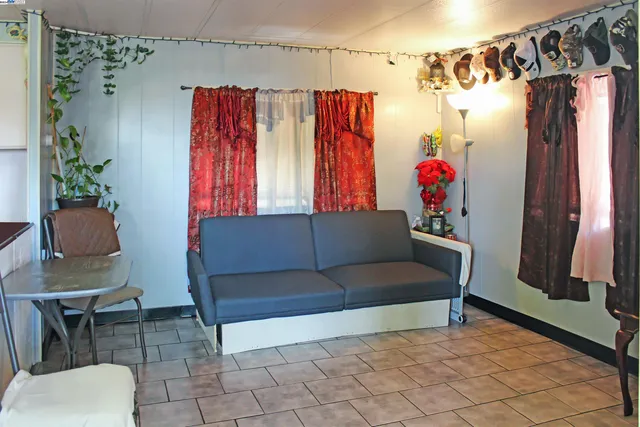 a living room with furniture and a red couch