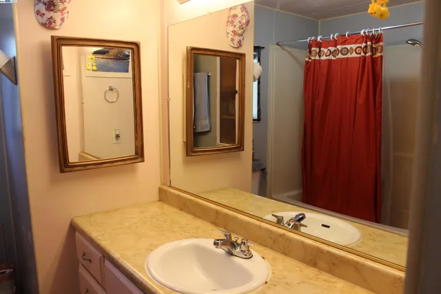 a bathroom with a sink vanity and a mirror