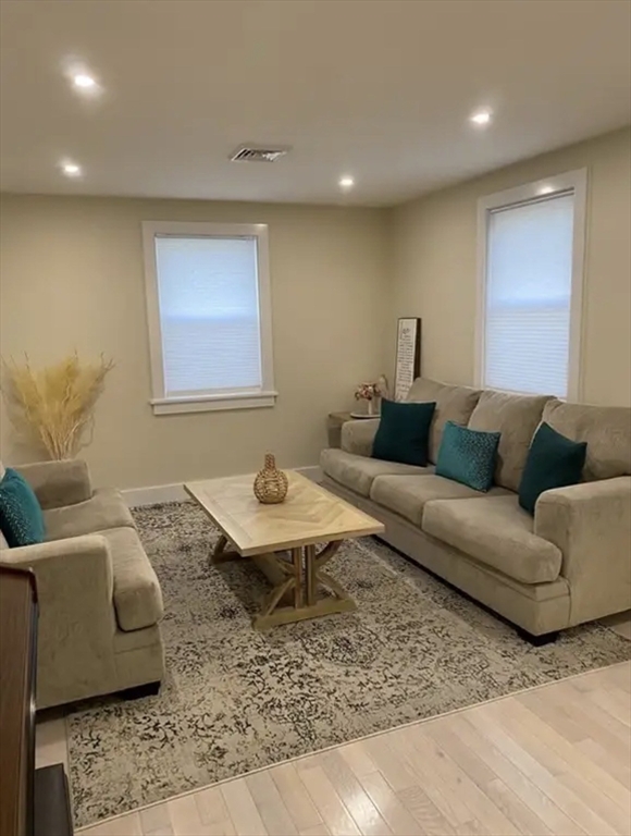 65 Louis Street, Unit A Barnstable, MA 02601 - Photo 13 of 28 a living room with furniture and wooden floor