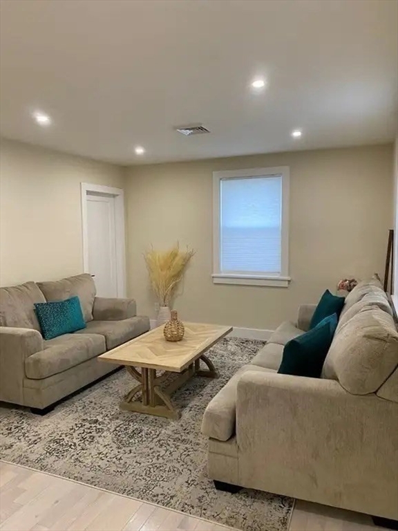 65 Louis Street, Unit A Barnstable, MA 02601 - Photo 18 of 28 a living room with furniture and wooden floor