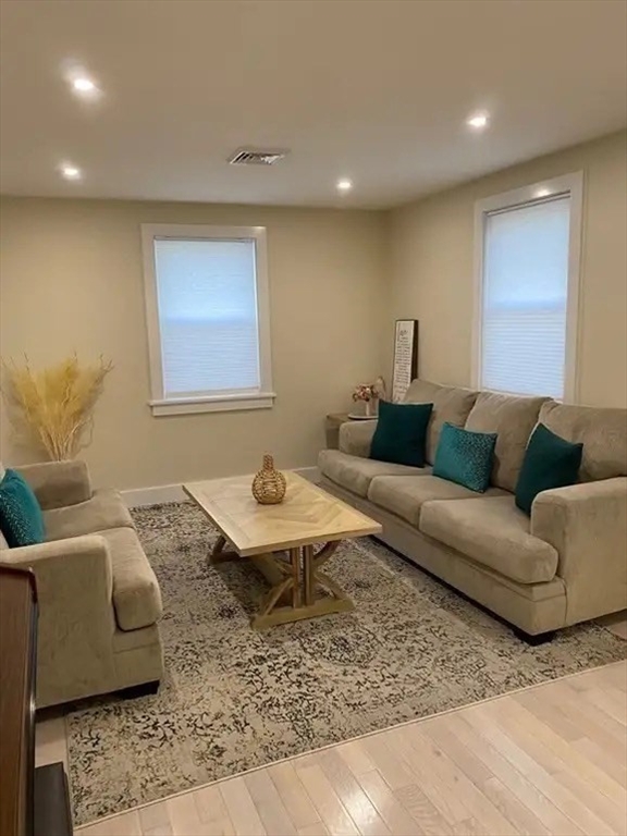 65 Louis Street, Unit A Barnstable, MA 02601 - Photo 19 of 28 a living room with furniture and wooden floor