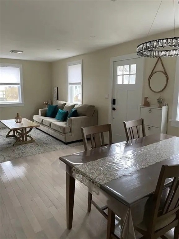 65 Louis Street, Unit A Barnstable, MA 02601 - Photo 20 of 28 a view of a dining room with furniture window and wooden floor